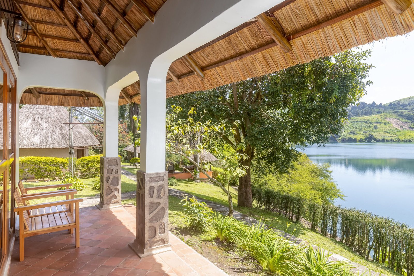 Double cottage veranda facing Lake Nyinabulitwa through tropical gardens