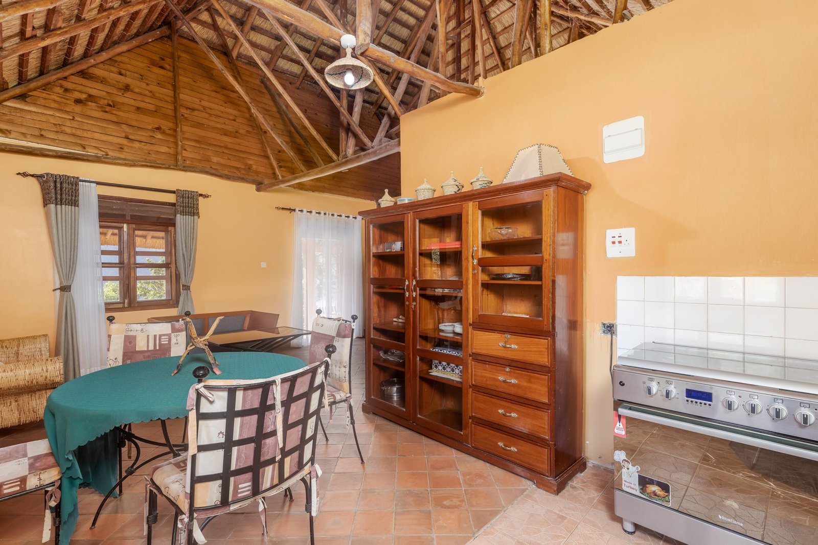 Practical kitchen and dining area inside the Bahundu family cottage at Bahundu near Fort Portal, Uganda
