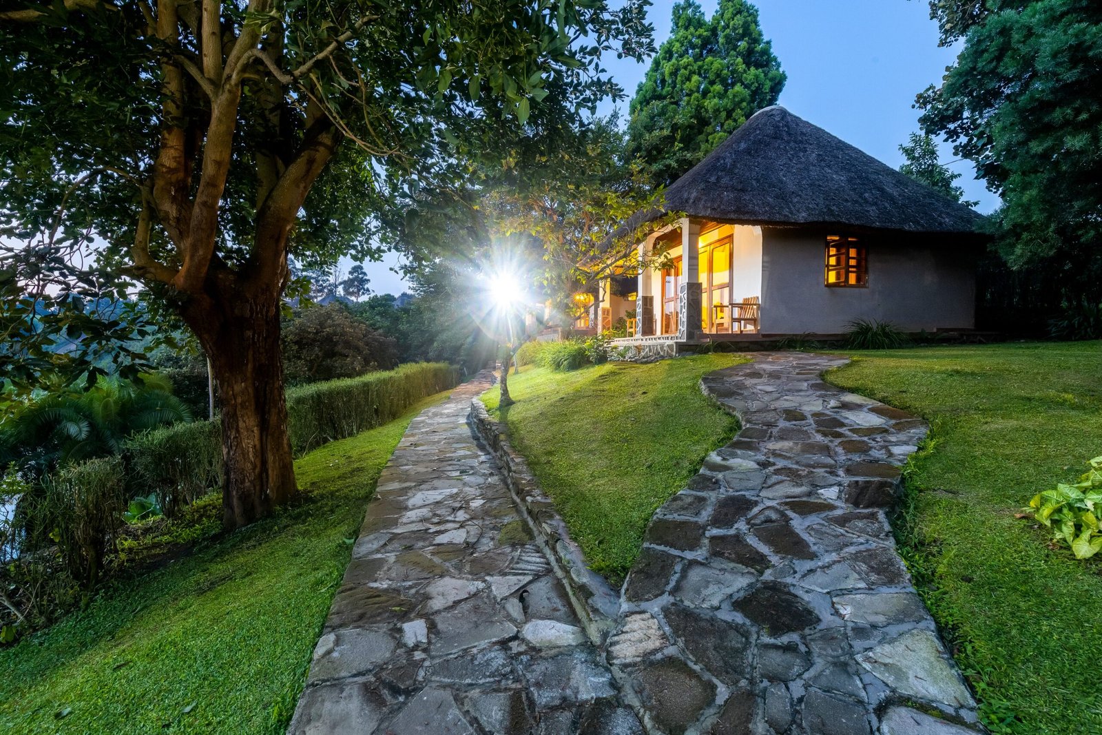 Warm cottage lights in the silent Bahundu gardens near Fort Portal