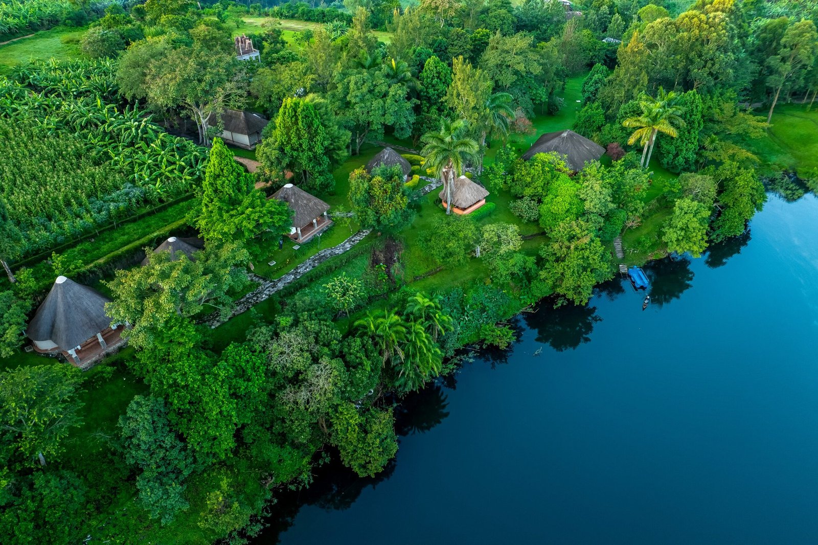 Forested crater lake and garden cottages at Bahundu near Fort Portal