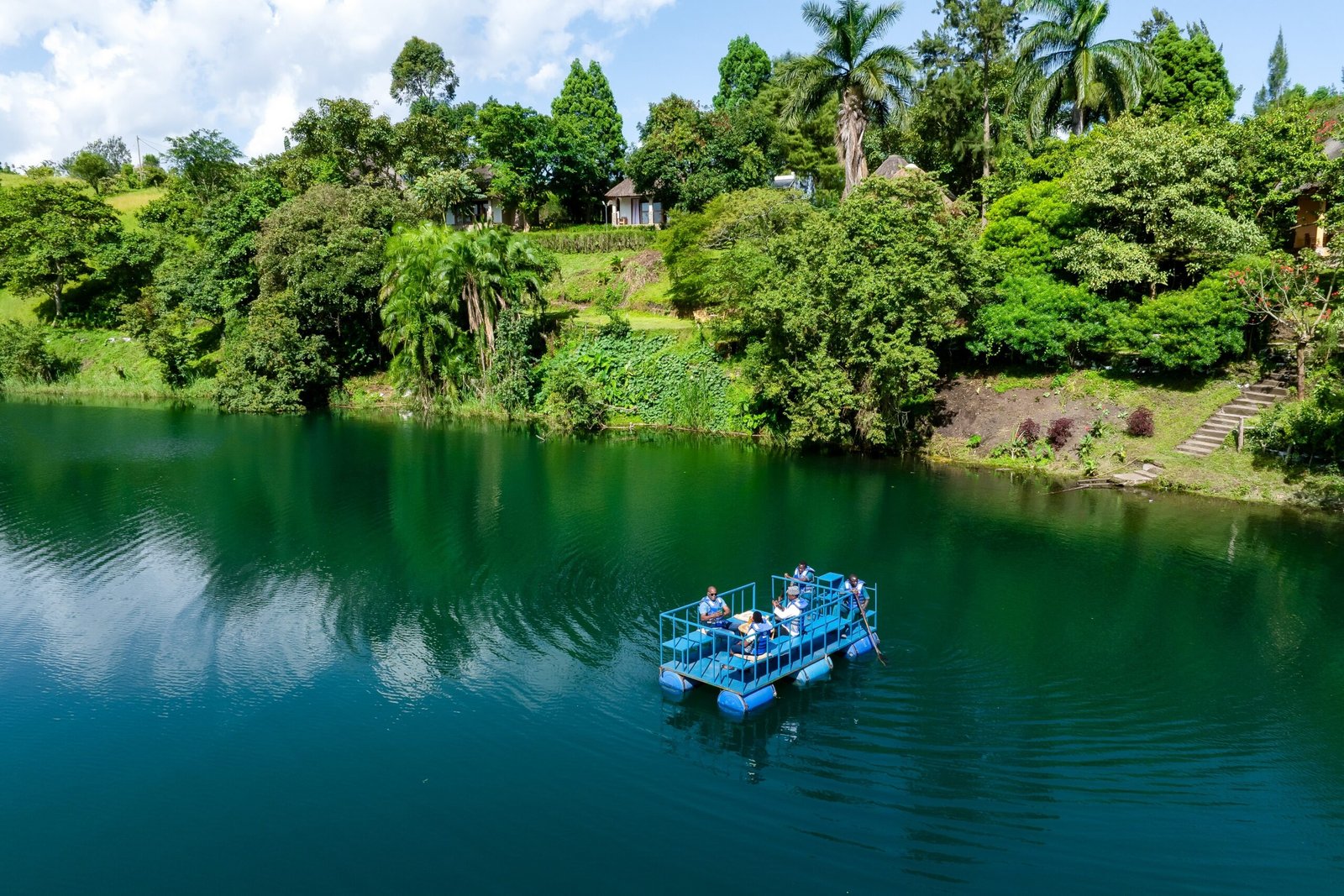 Guests talking together on a gentle boat ride across Lake Nyinabulitwa