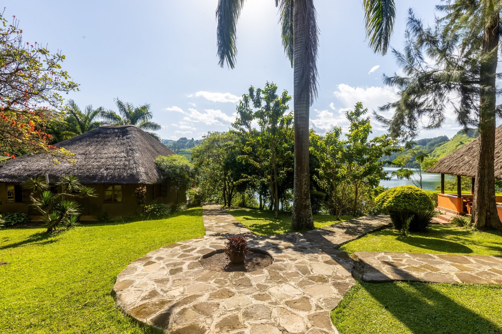The stone firepit circle in the lodge gardens beneath tall palms
