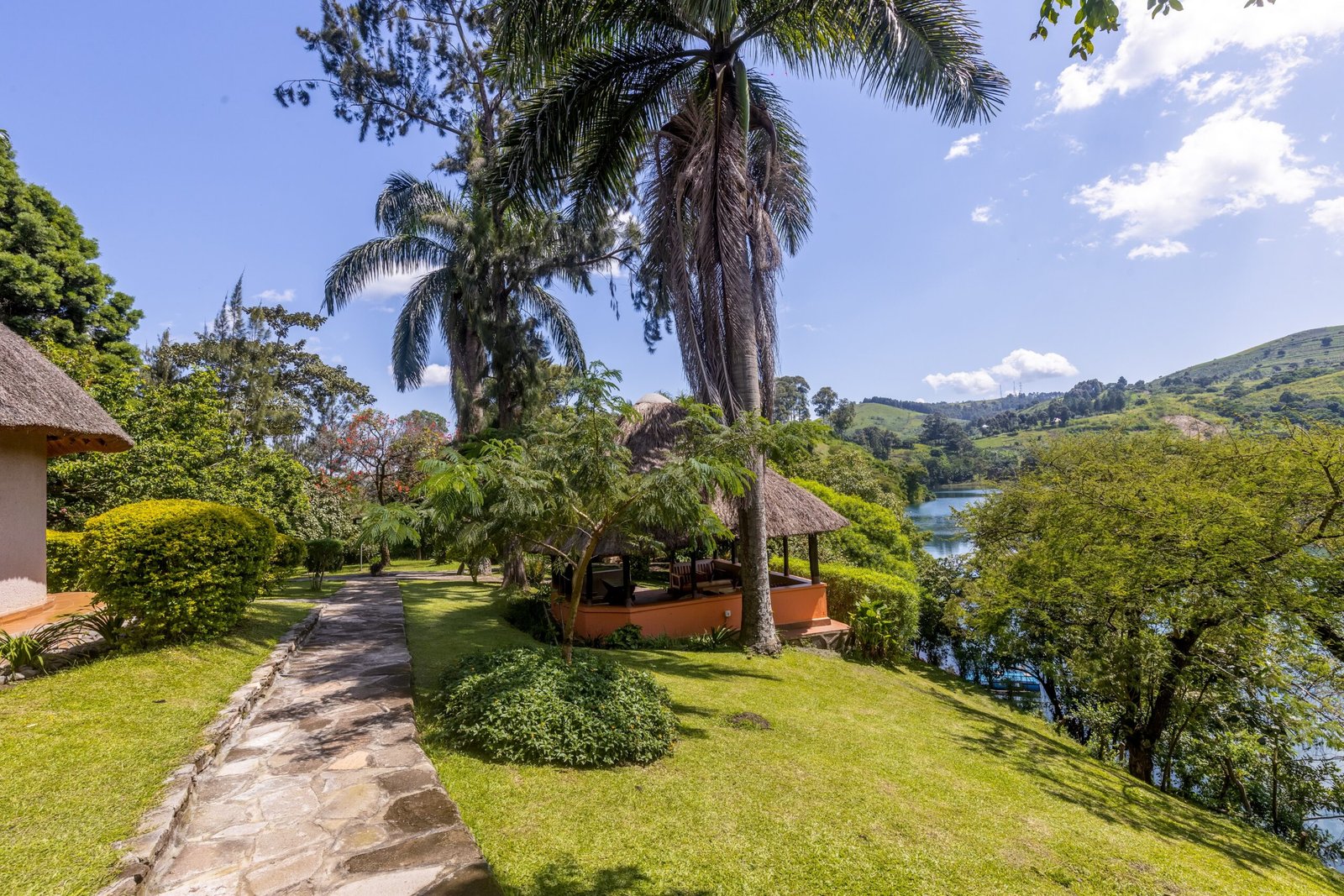 Open lawns and tropical planting with views toward Lake Nyinabulitwa