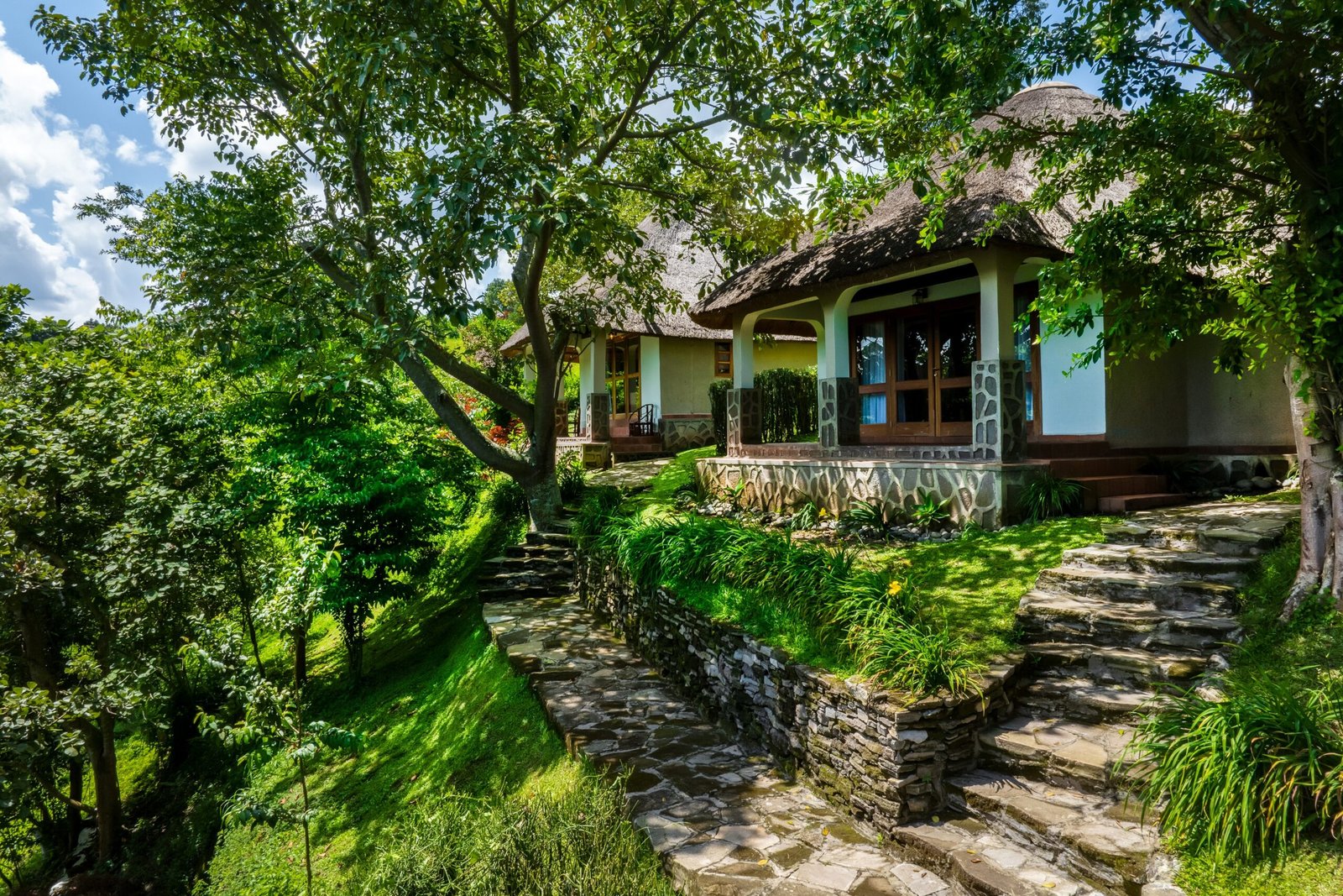 Green garden path marking a quiet arrival at Bahundu Safari Lodge near Fort Portal, Uganda