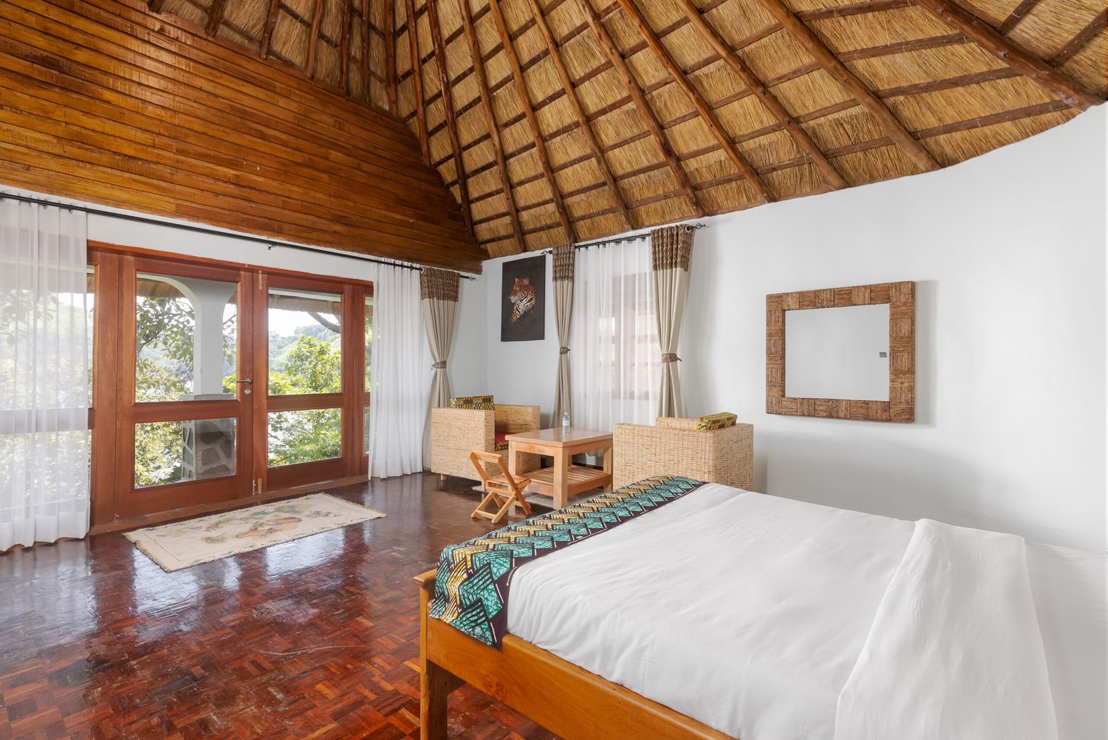 A king cottage bed with glass doors opening toward the lake
