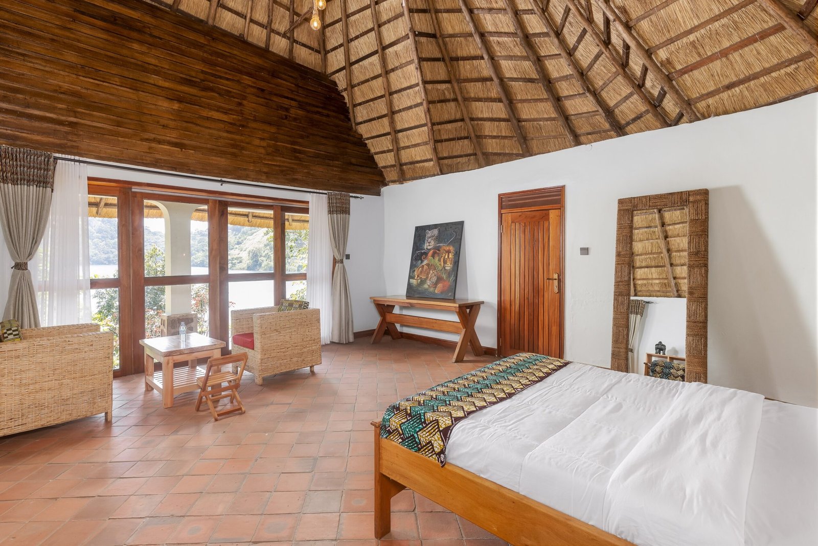 Quiet king cottage room facing the green crater lake landscape at Bahundu near Kibale Forest in Uganda