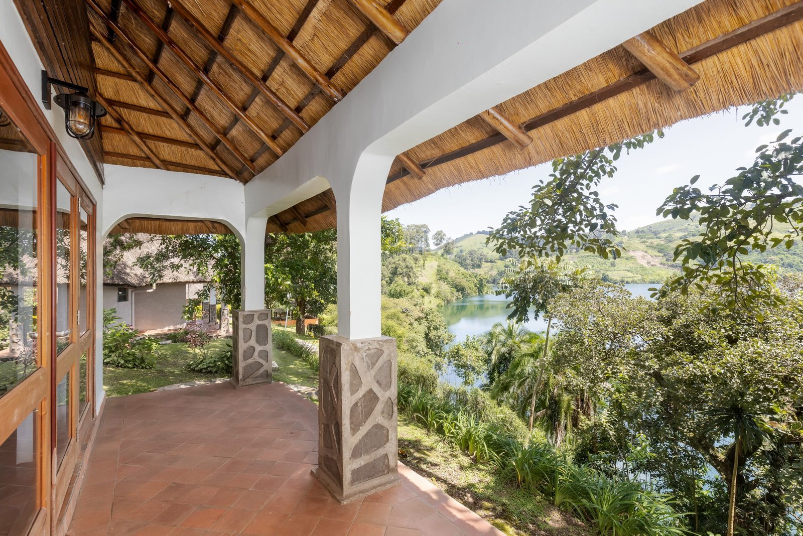 Private king cottage veranda for a romantic lakeside staycation at Bahundu near Fort Portal